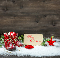 christmas decoration red stars and antique baby shoes in snow
