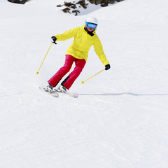 Skiing, skier, winter sports - woman skiing downhill