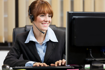 Female support assistant working at the helpdesk