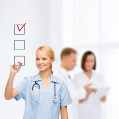 doctor or nurse drawing checkmark into checkbox