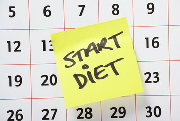 Start Diet Reminder note stuck on a Calendar