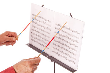 music director with baton and sheet stand