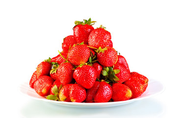 pile of garden strawberry on a plate isolated