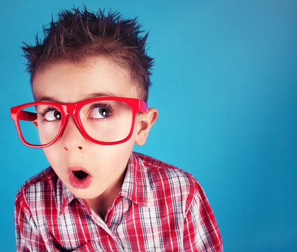 Surprised five years old boy wearing glasses