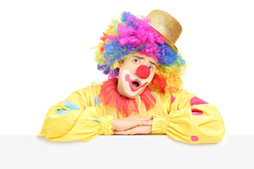 Male circus clown making a grimace on a blank panel
