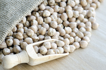 Chickpeas in a wooden spoon and bag