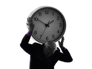 senior business man holding time clock silhouette