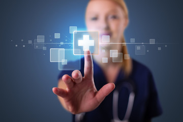 Young nurse pressing modern medical type of buttons