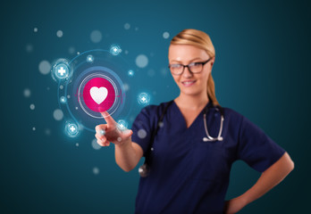 Young nurse pressing modern medical type of buttons