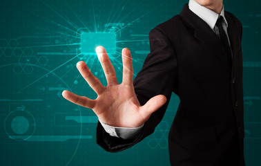 Businessman pressing high tech type of modern buttons