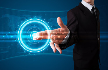 Businessman pressing high tech type of modern buttons