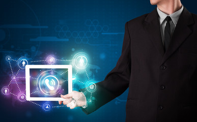 Businessman showing social networking technology with colorful l