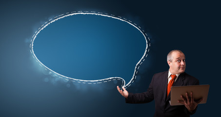 funny businessman holding a laptop and presenting speech bubble