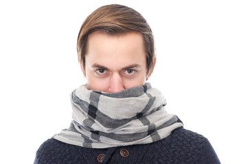 Portrait of a young man with scarf covering face