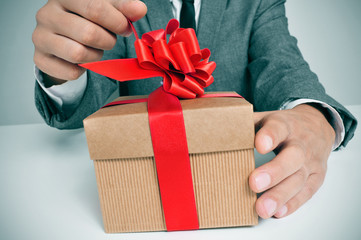 man in suit opening a gift