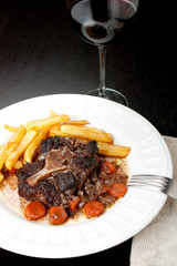 Oxtail stew with carrots and fries