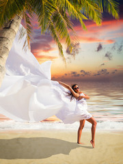Fototapeta na wymiar Beautiful Girl With White fabric on The Beach.