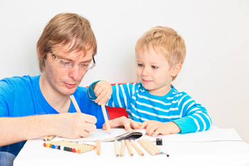 father and son drawing together, early education