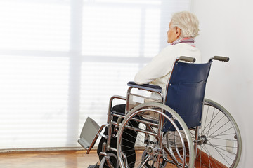 Lonely senior woman in wheelchair - obrazy, fototapety, plakaty