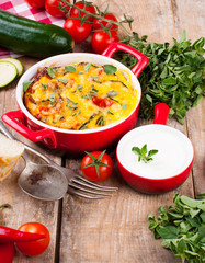 Vegetable casserole in a red pot