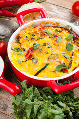 Vegetable casserole in a red pot
