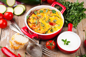 Vegetable casserole in a red pot