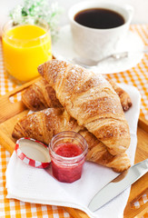 Breakfast with croissants, cup of coffee and orange juice