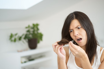 Woman checking the end of her hair for split ends