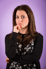 Pensive Young Woman on Violet Background