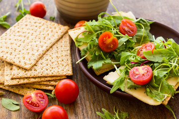 Vegetarian crispbread  with tomatos, cheese and salad mix