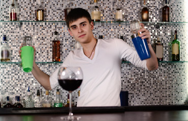 Barman mixing cocktails at the bar