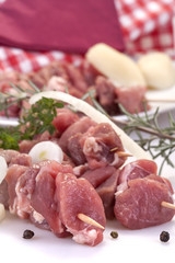 fresh pork skewers with vegetables, onions and rosemary