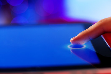 Closeup of finger touching tablet-pc screen