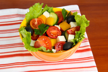Tasty Greek salad on wooden background