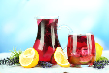 Red basil lemonade in jug and glass,