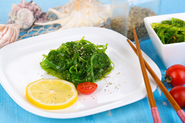 Sea kale on plate on wooden table close-up
