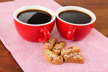 Red cups of strong coffee and cookies