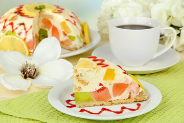 Delicious jelly cake on table on light background
