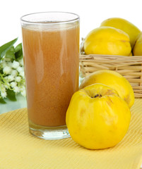 Sweet quince with juice on table on white background