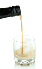 Pouring liquor in glass isolated on white