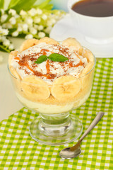 Delicious dessert with banana and caramel on table close-up