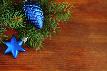 Beautiful Christmas decorations on fir tree on wooden