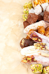 Tasty oriental sweets, on brown background