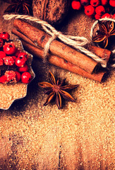 Brown sugar, anise star and cinnamon sticks on wooden table macr