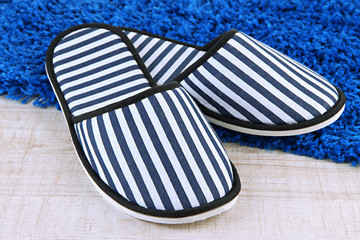 Striped slippers on floor background