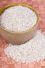 barley groats in a brown bowl