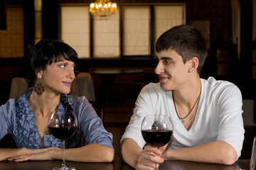Smiling young couple on a date out drinking