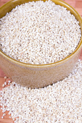 barley groats in a brown bowl