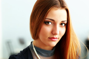 Naklejka premium Young beautiful pensive woman looking at camera