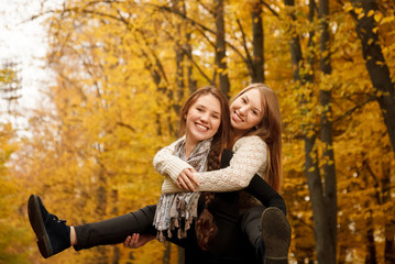 piggyback ride in autumn forest